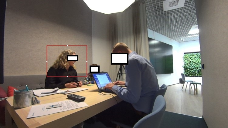 A picture similar to picture 3, but with a computer-generated box around the customer’s head.